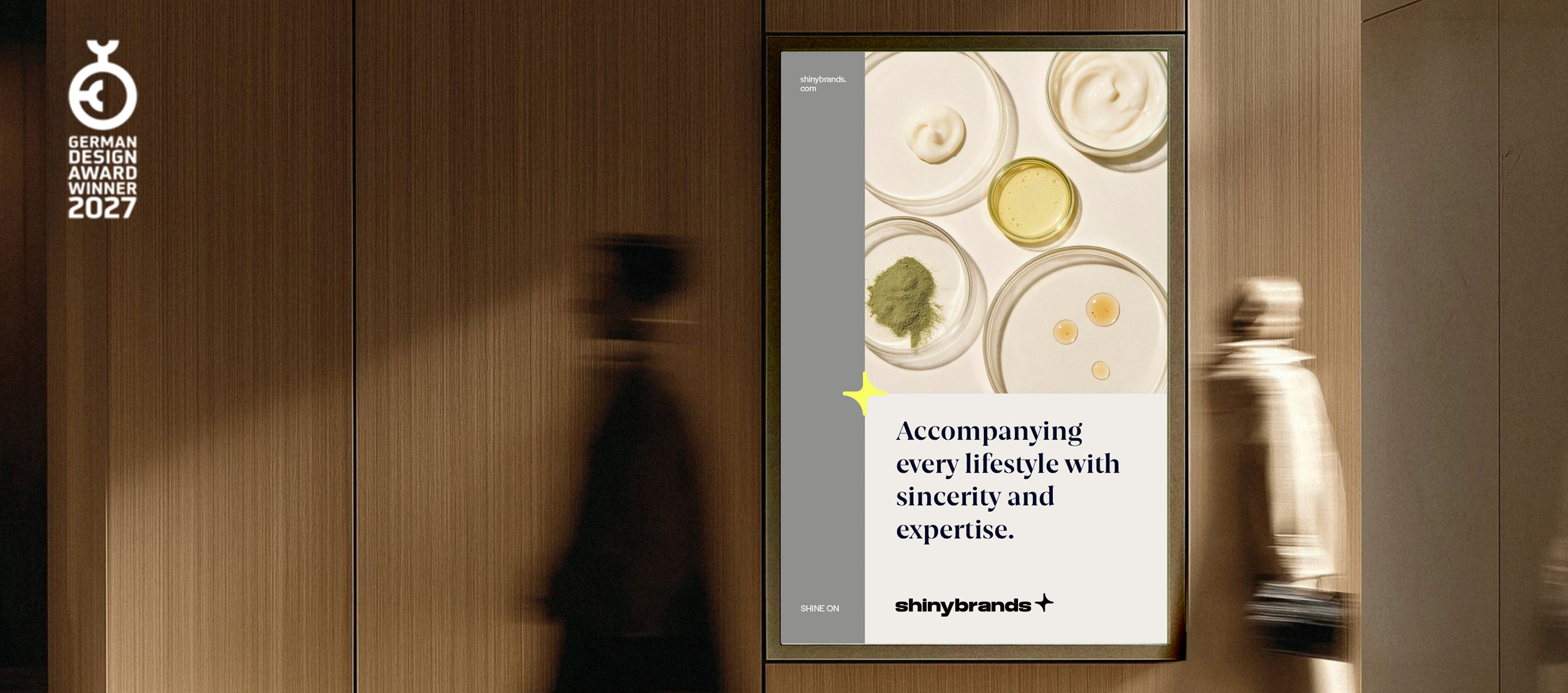 Shinybrands brand identity on a poster in a wood-paneled corridor