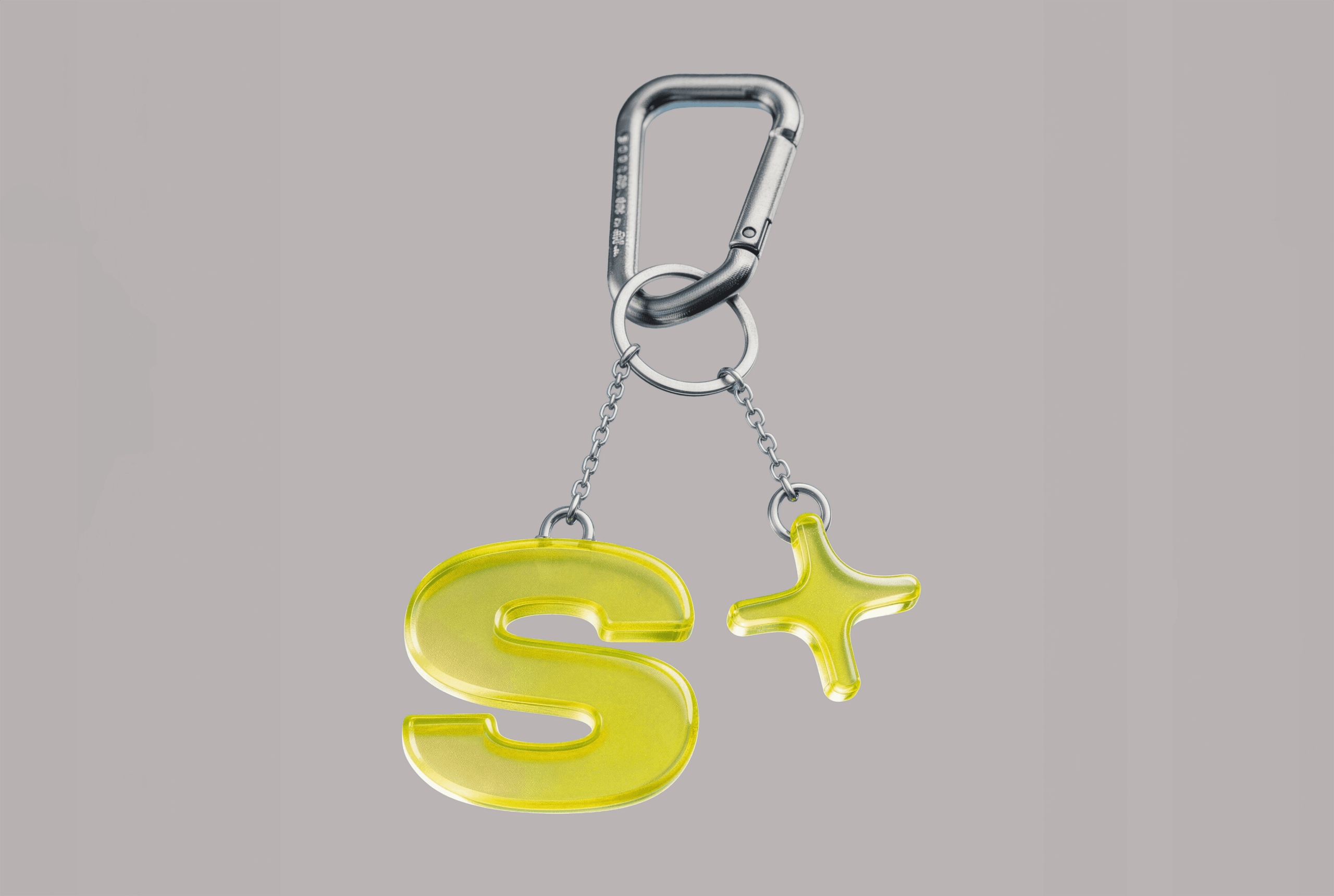 S+ symbol as a yellow keychain charm on a carabiner
