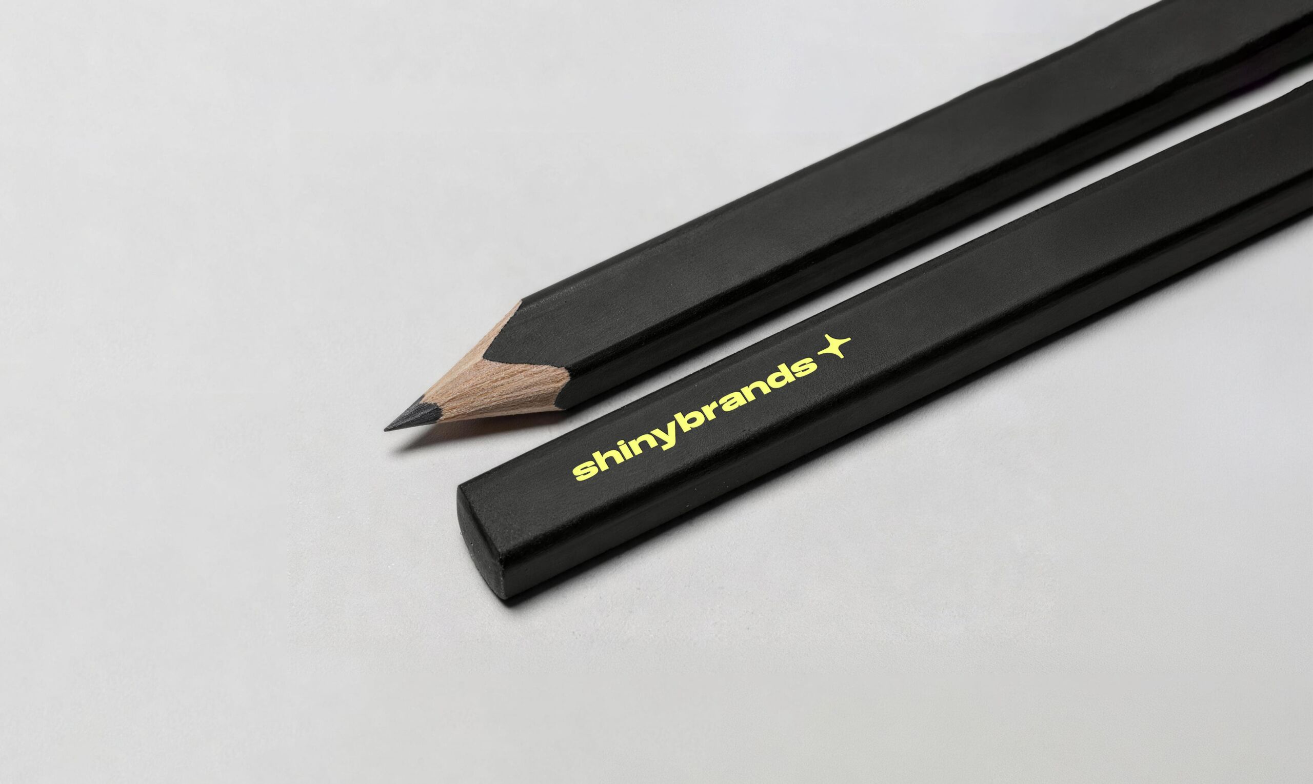 Black pencils printed with the Shinybrands logo in yellow
